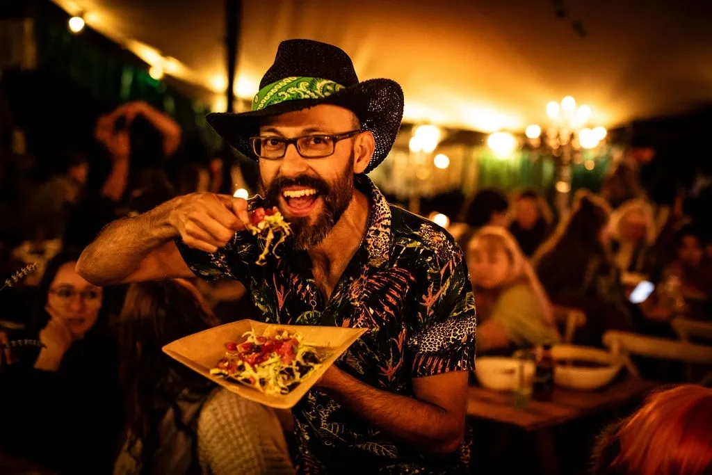 Festival-goer enjoying food at night