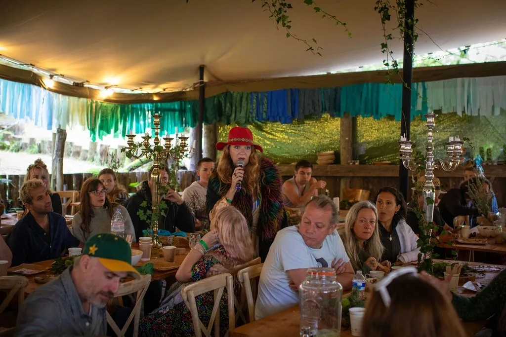 Long table under tent with speaker