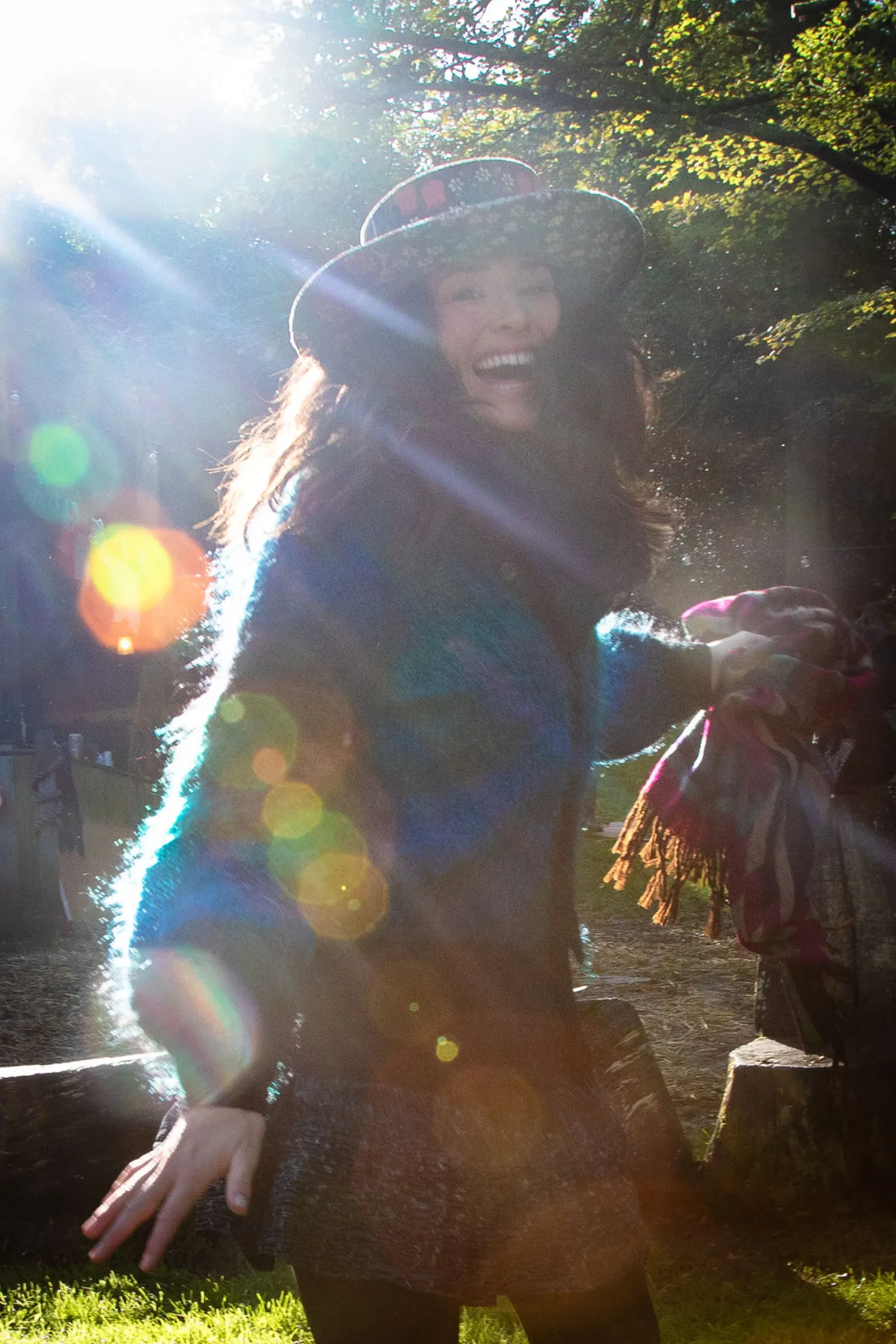 Festival-goer in a hat with sun flare