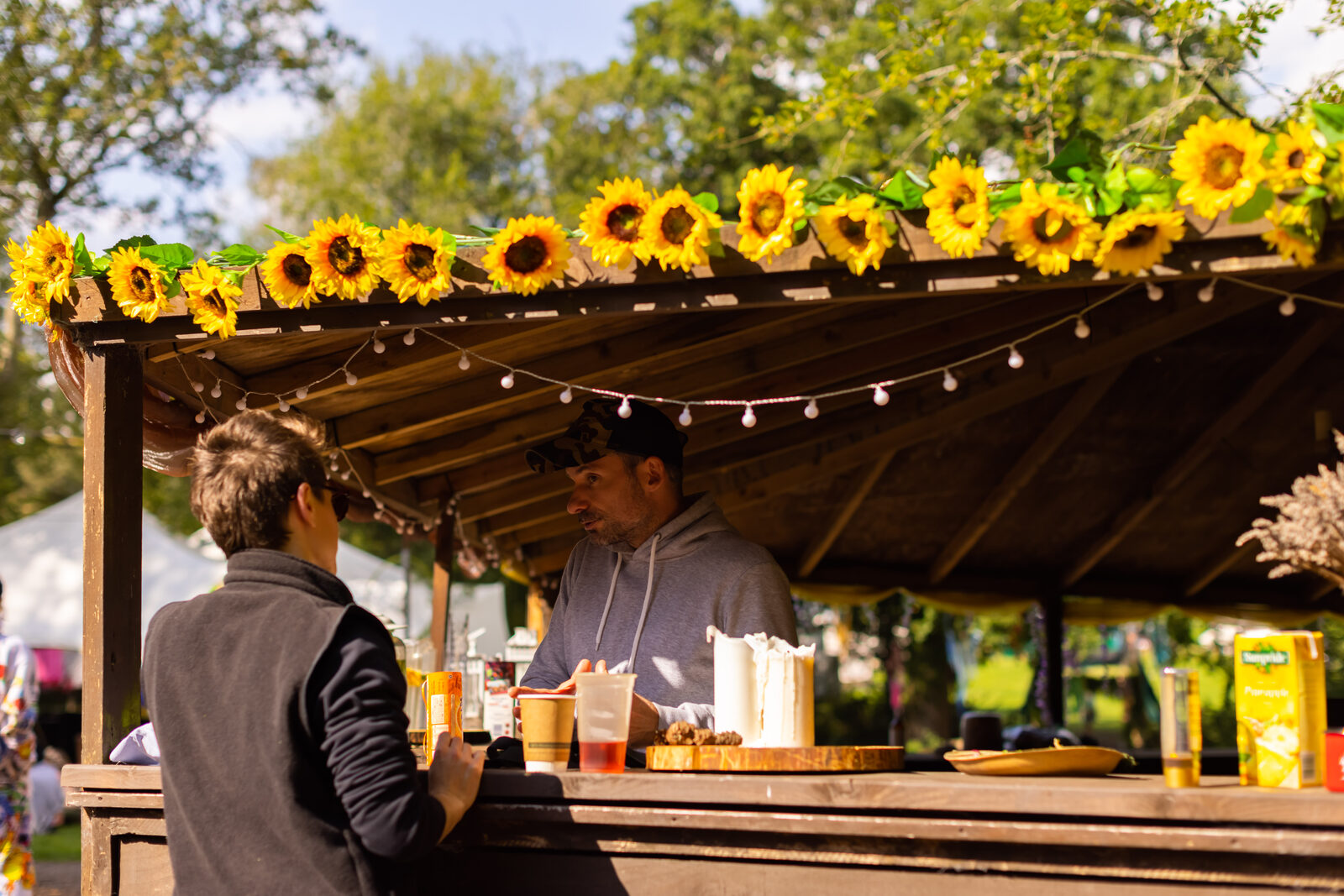 Sunflower-strung marketplace stall in the field