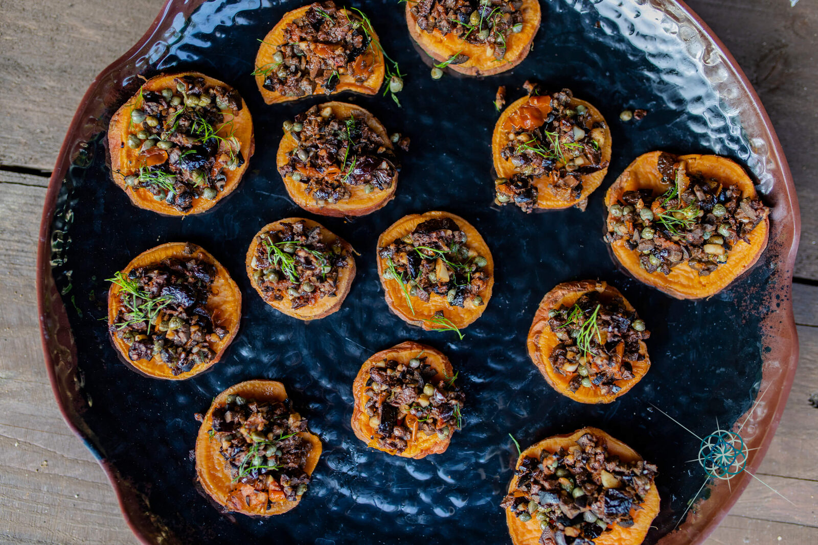 Plate of sweet potato canapés with herbs and seeds
